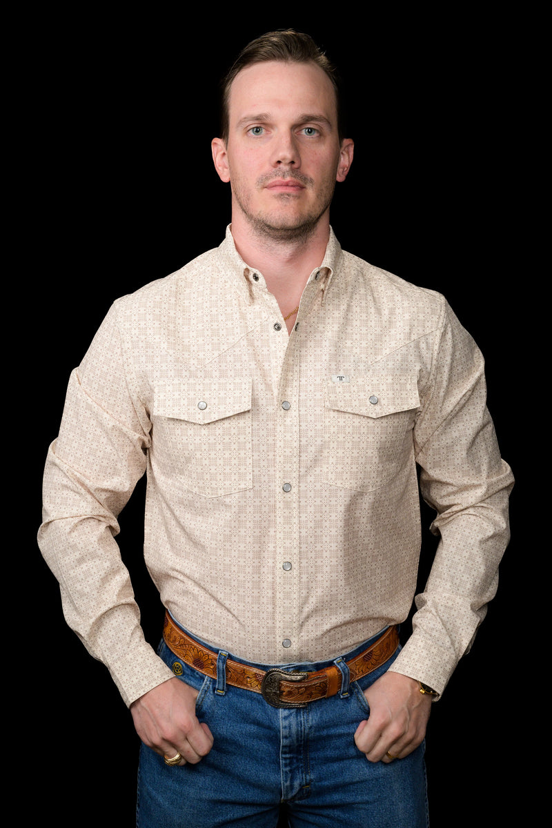 Man wearing a beige checkered shirt and blue jeans on a black background