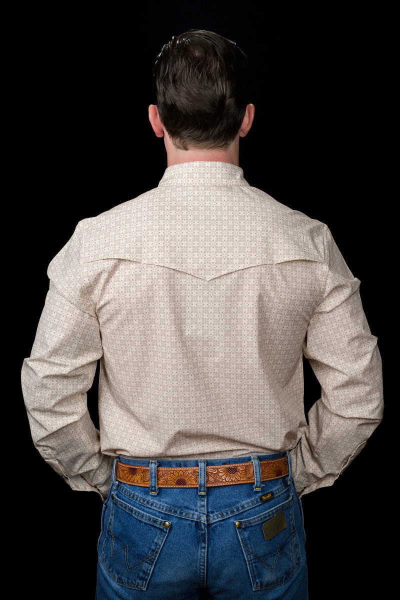 Man wearing a beige checkered shirt and blue jeans from behind on a black background