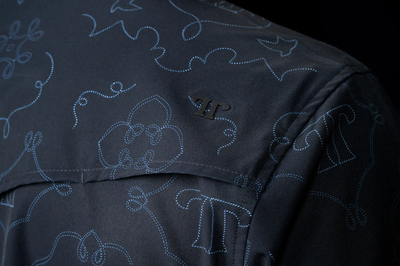 Navy blue fabric with embroidered patterns on a black background