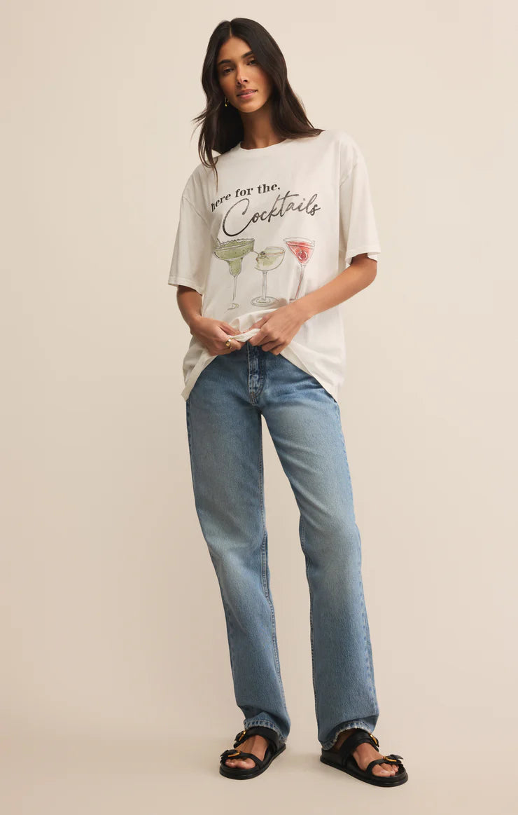 Woman wearing a graphic t-shirt and jeans on a plain background
