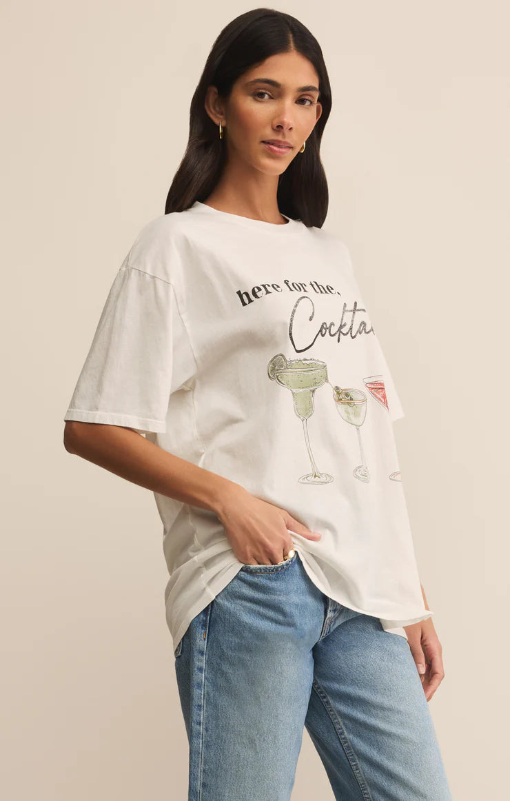 Woman wearing a white t-shirt with a graphic design on a beige background