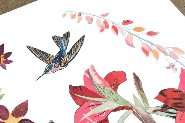 Archival print of an original paper collage featuring a hummingbird in flight surrounded by blooming summer flora including a cactus, butterflies and fuzzy caterpillar.