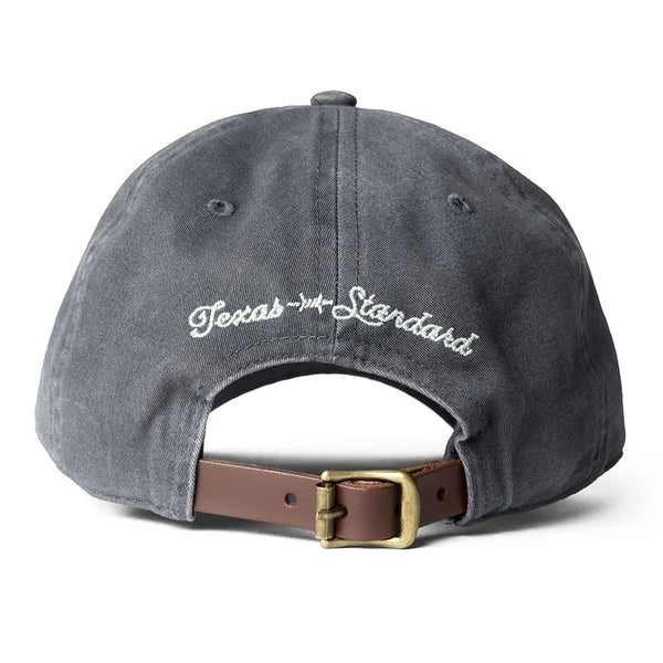 Gray cap with 'Texas Standard' logo and brown leather strap on a white background