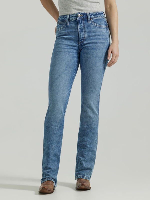 Woman wearing medium wash boot cut jeans with low ride waste