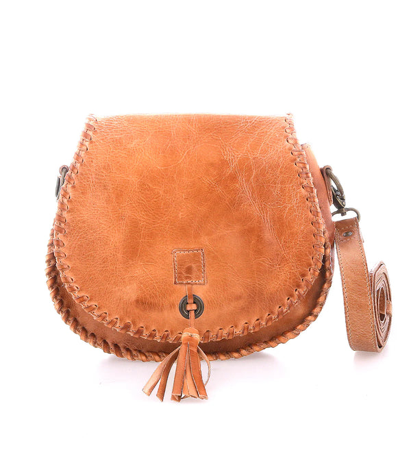 Brown leather crossbody bag with tassel on a white background