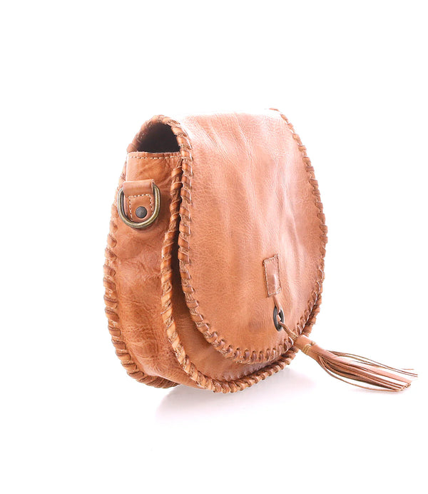 Brown leather handbag with a tassel on a white background