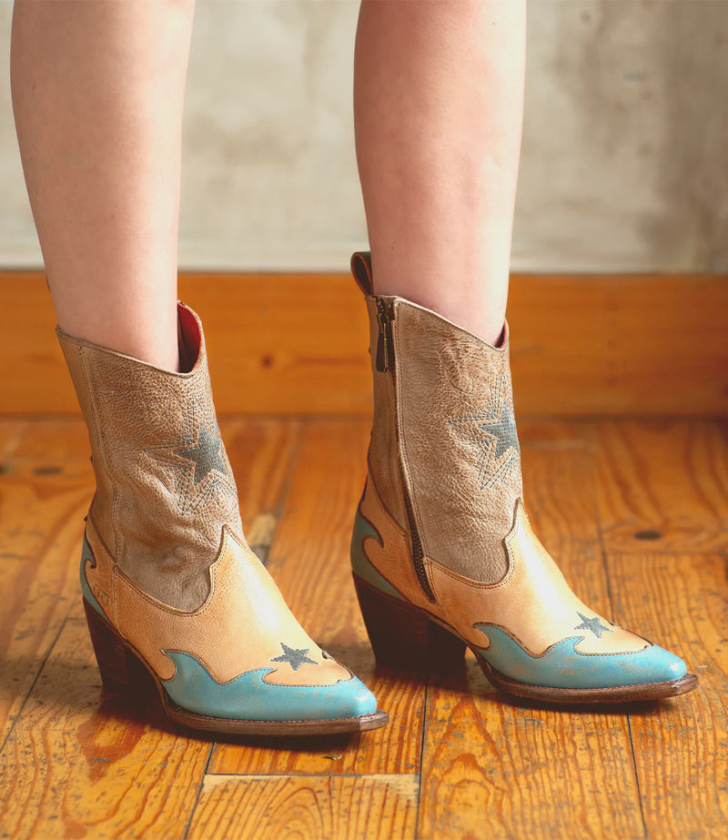 Bootie with pinkish tan hues with blue embellishments and a blue star on the front