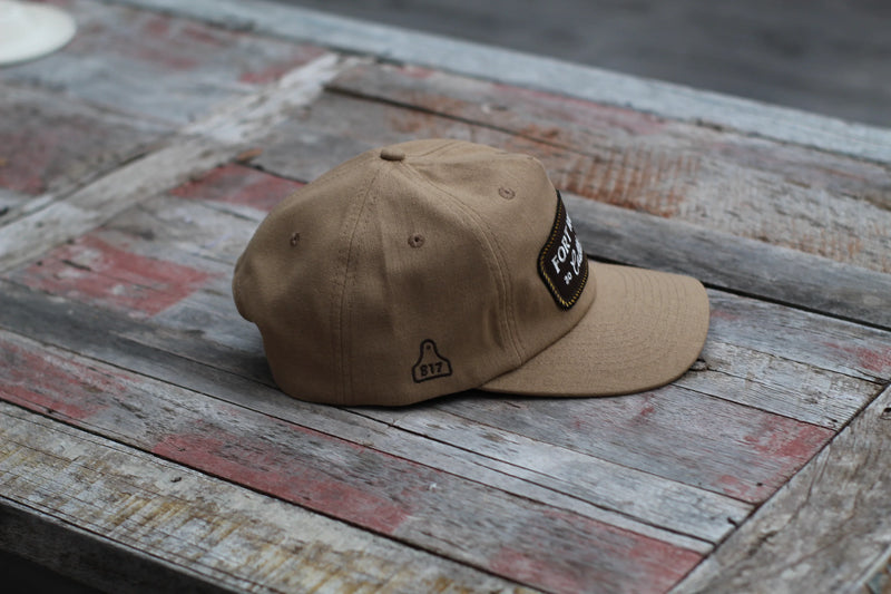 Brown cap with a patch on a rustic wooden surface