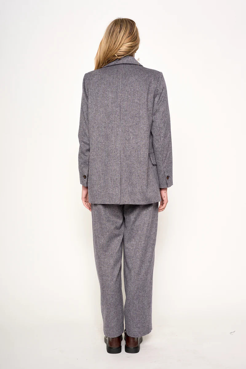 Person wearing a gray suit on a white background
