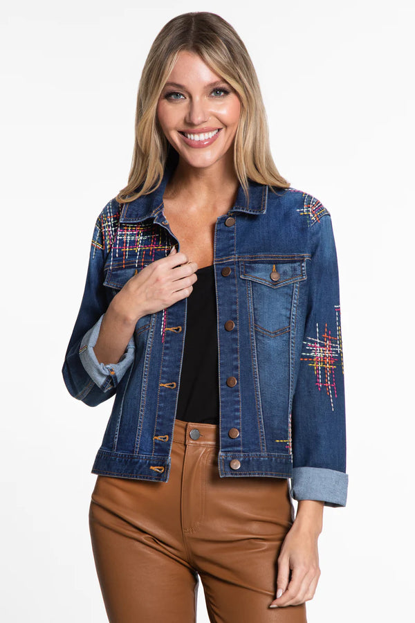 Woman wearing embroidered medium wash denim jacket