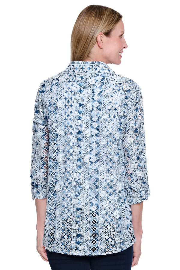Woman wearing a blue floral patterned blouse on a white background