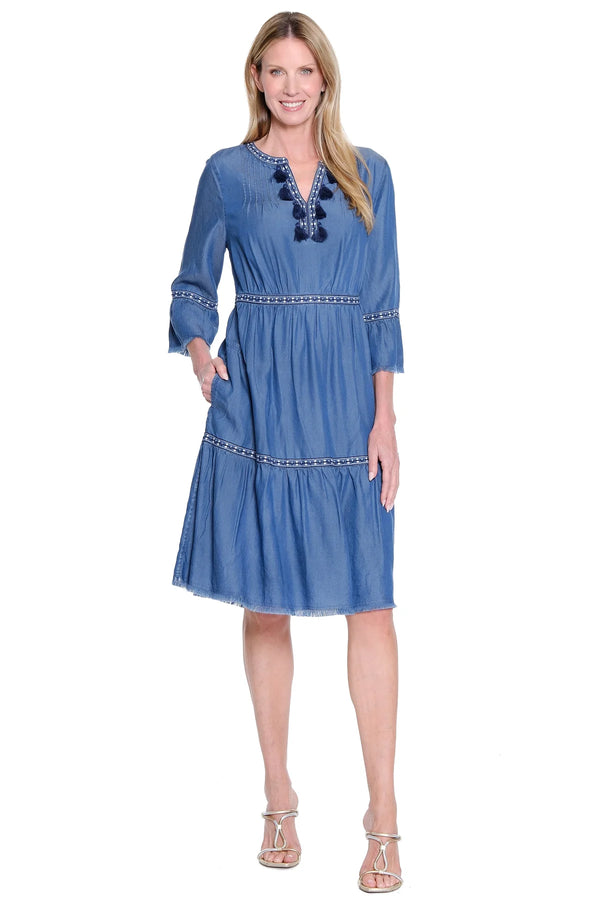 Woman wearing a blue dress with a white background