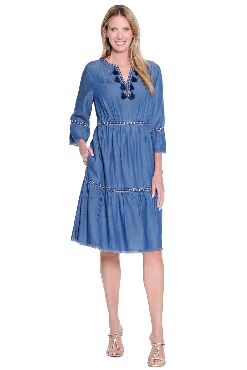 Woman wearing a blue dress with a white background