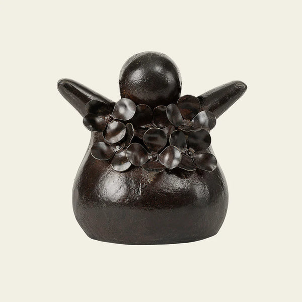 Cast iron chubby angel with flowers all over the top portion 