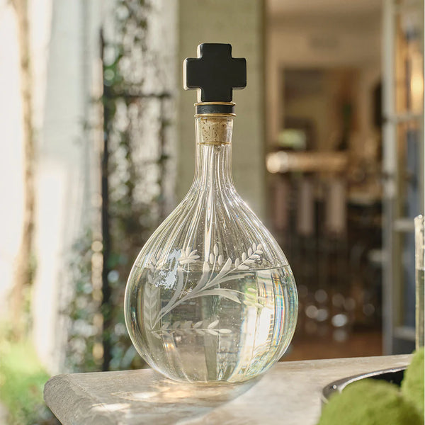 Glass decanter with leaves etched onto the side and cast iron with cork top and