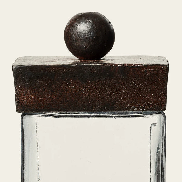 Glass vessel with cast iron base and lid with cast iron ball on the top of the lid