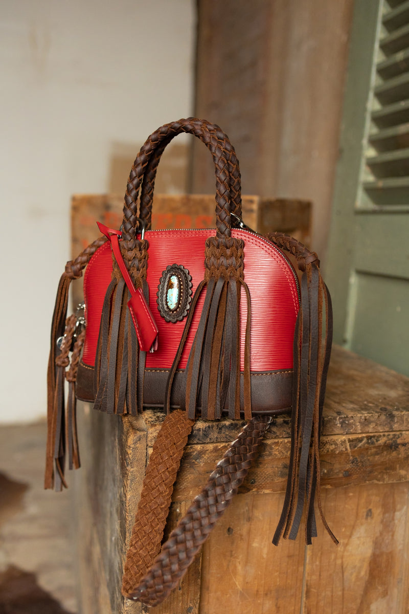 Red Nano Alma Bag featuring a 25 carat number eight turquoise oval embellishment and leather fringe braided detailing and fringe