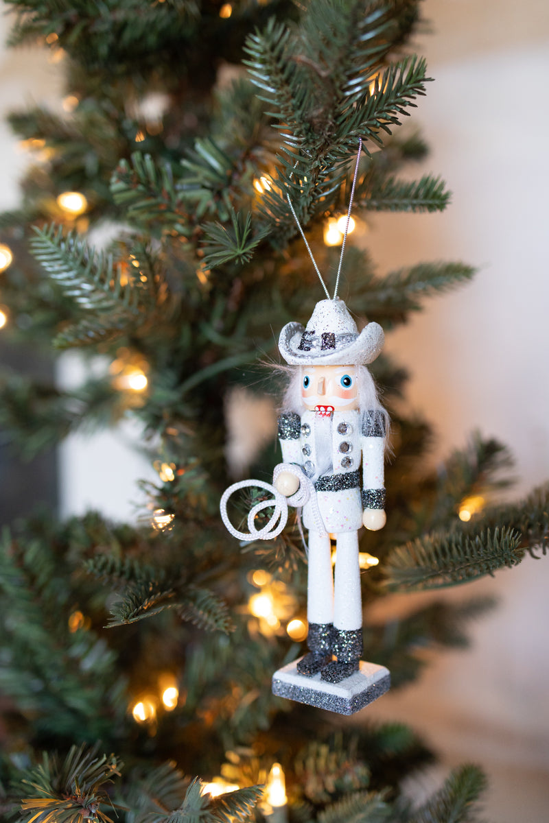 WOODEN COWBOY NUTCRACKER ORNAMENT HOLDING A LASSO HANGING OFF A CHRISTMAS TREE