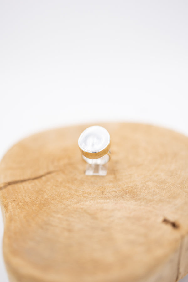 Blister pearl ring with sterling silver bezel on wooden display