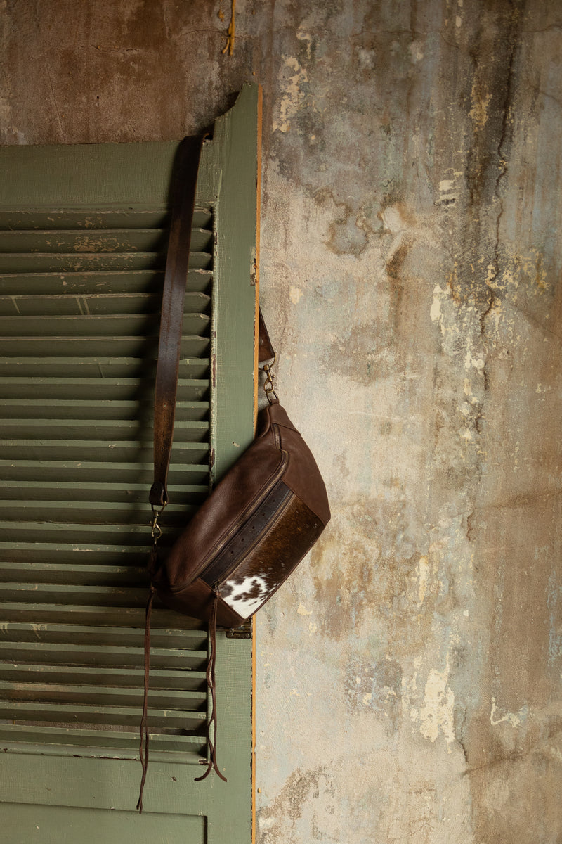 Brown leather sling bag with cowhide pocket
