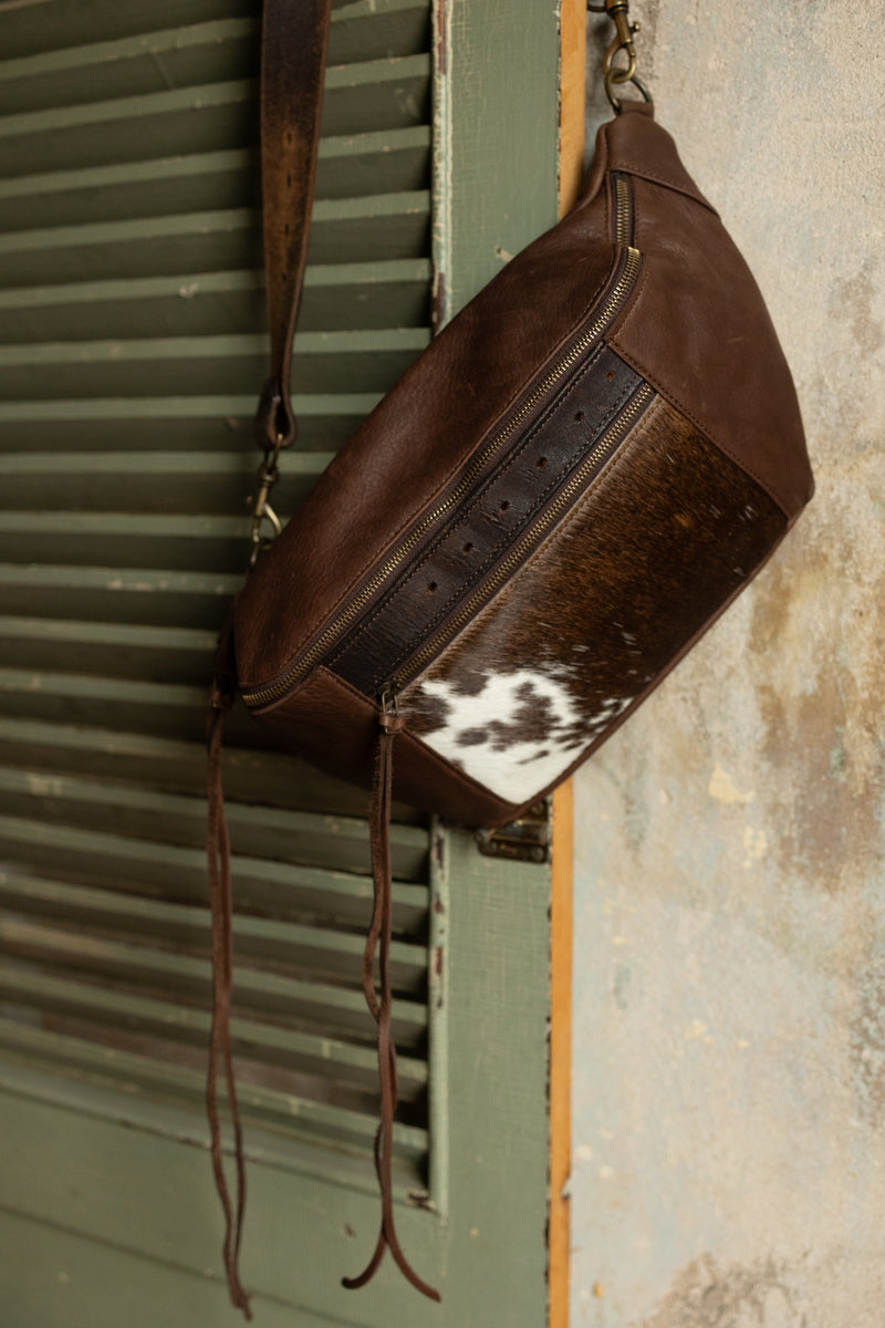 Brown leather sling bag with cowhide pocket