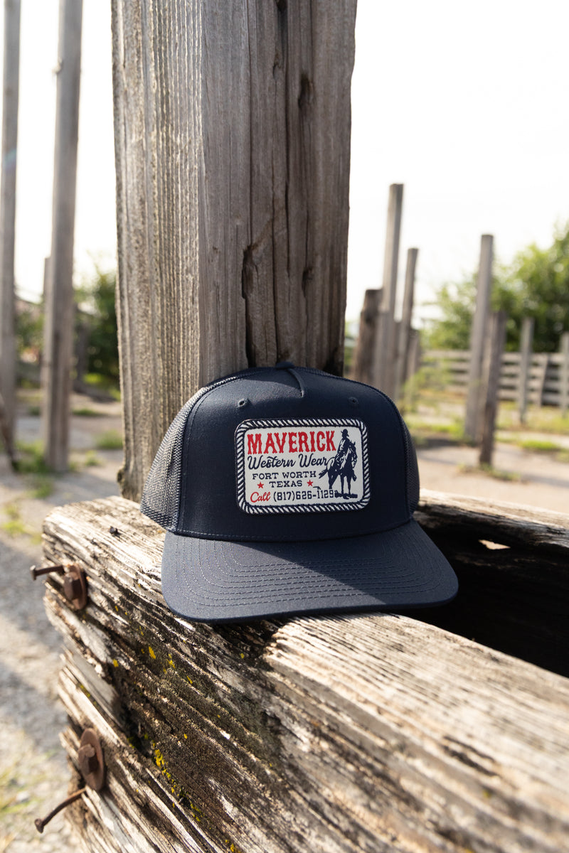 Black cap with a logo on a wooden post outdoors