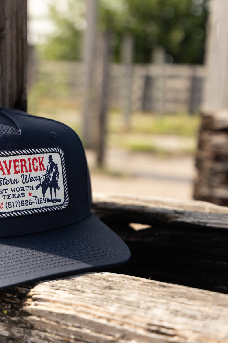 Navy blue cap with a logo on a wooden surface with a blurred background