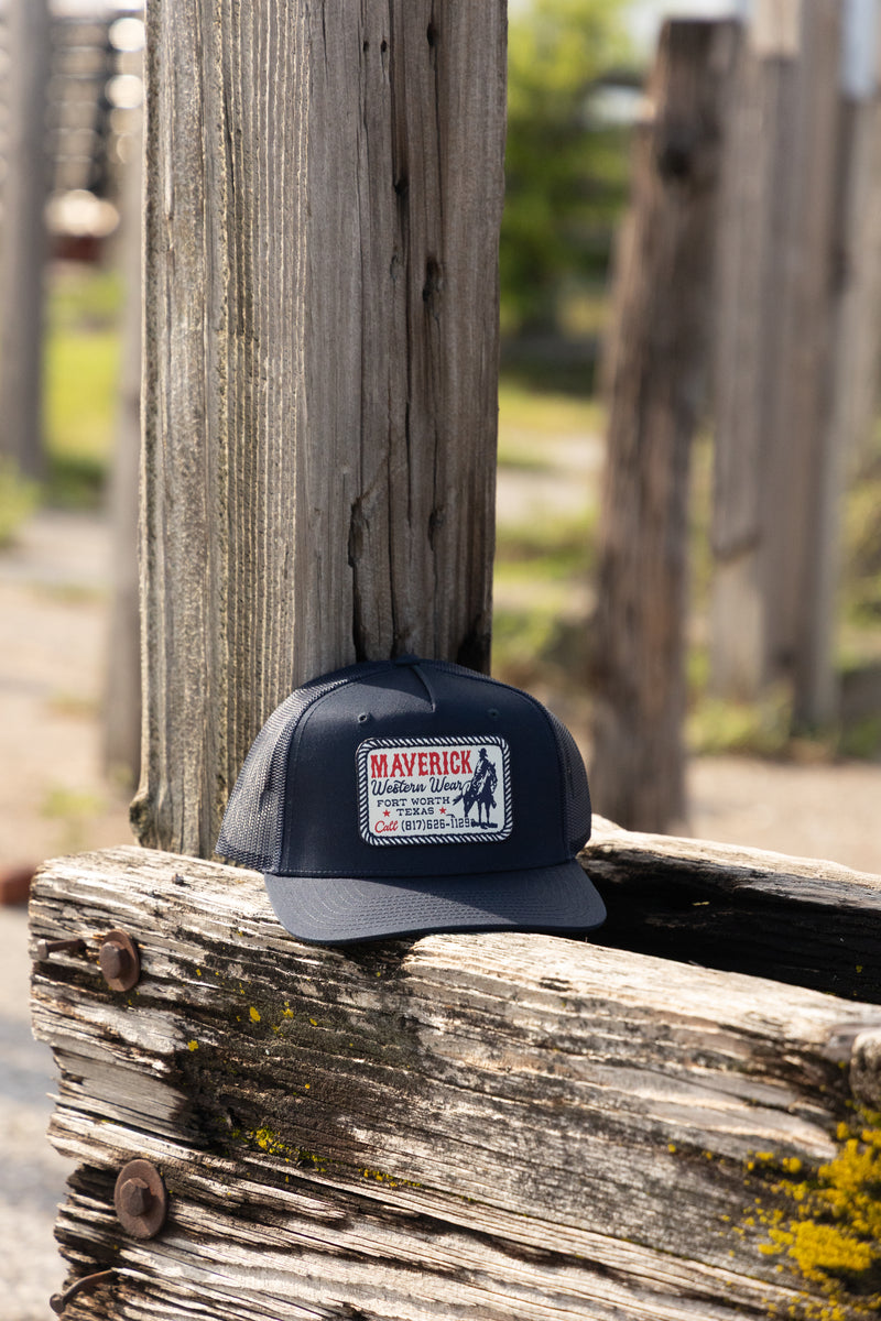 Navy blue cap with a logo on a wooden post outdoors