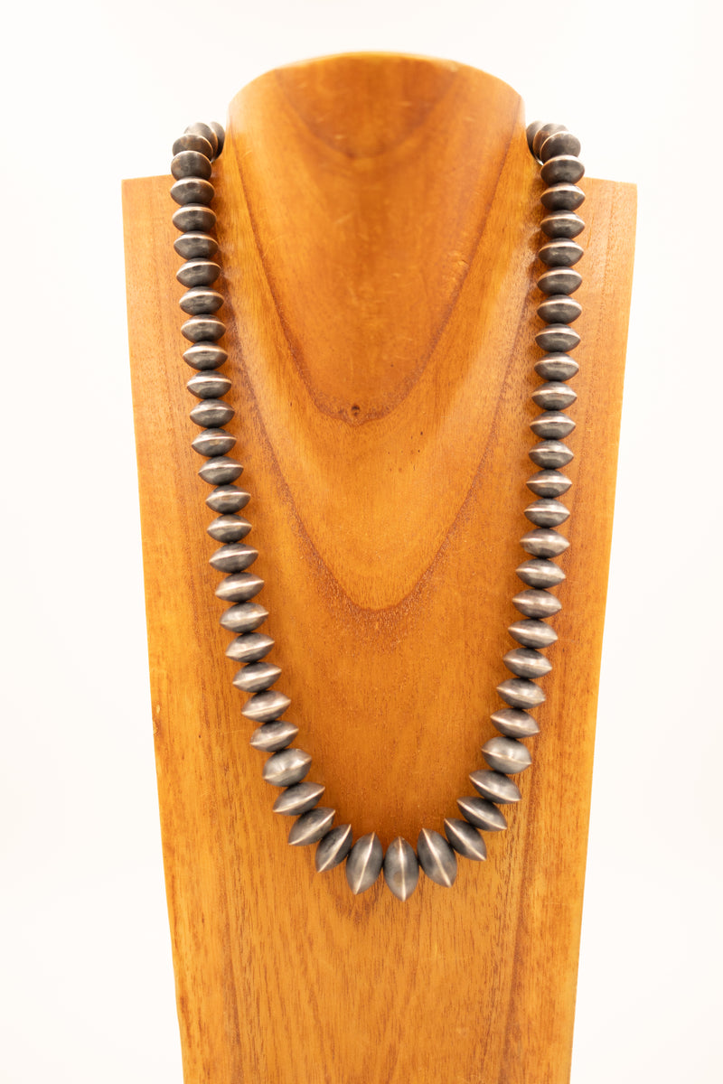 Large Navajo pearl saucer necklace on wooden neck display