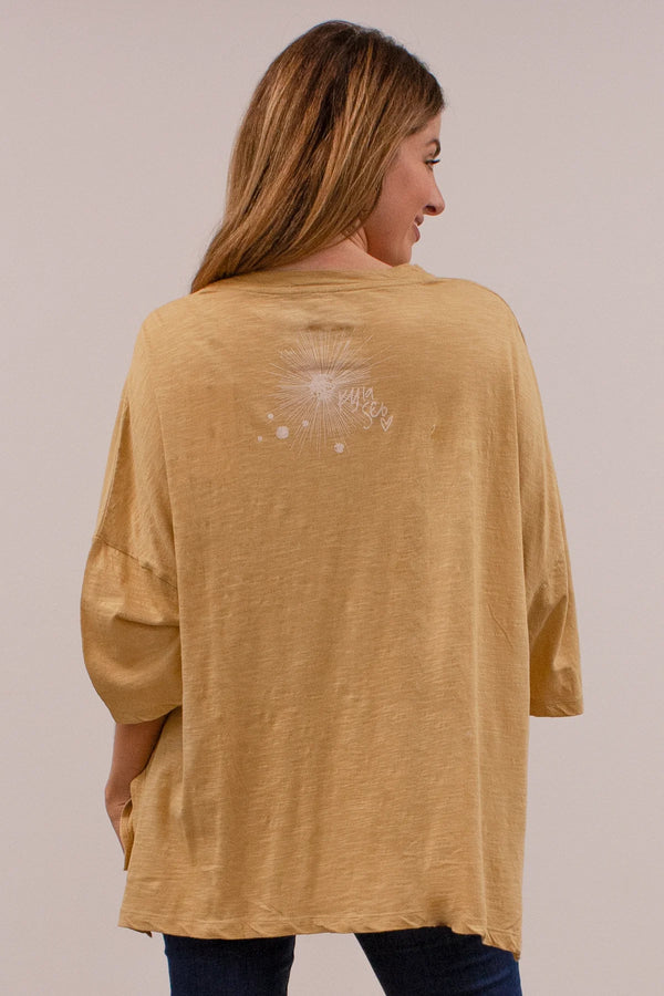 Yellow oversize top with elbow length top with side slits and planets with words "to the cosmos" printed on it.