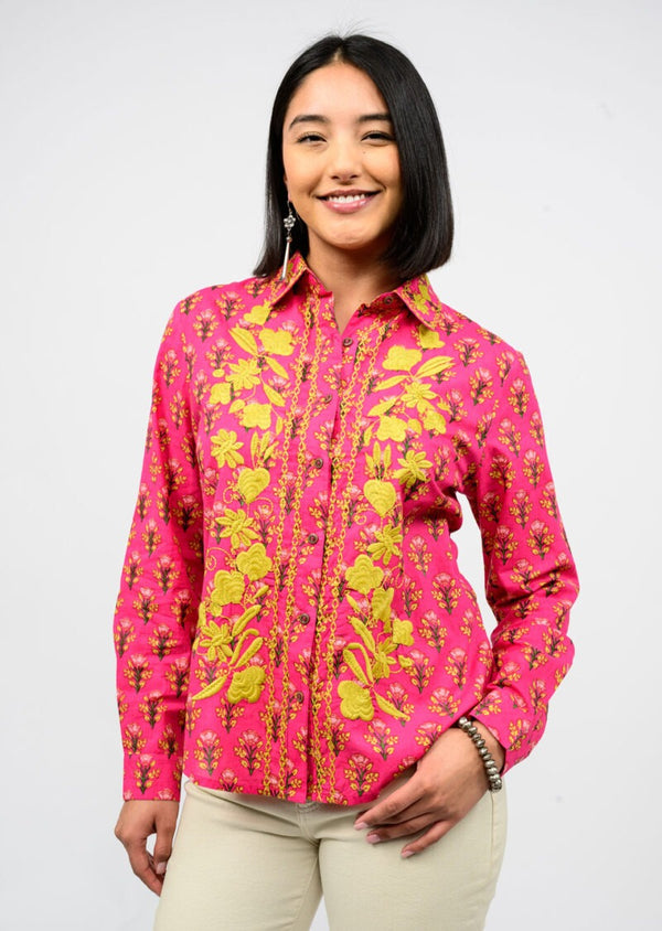 Woman wearing a pink floral shirt against a white background