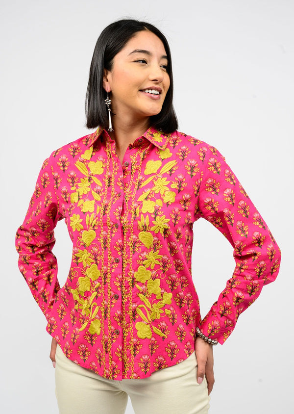 Woman wearing a pink floral shirt against a white background