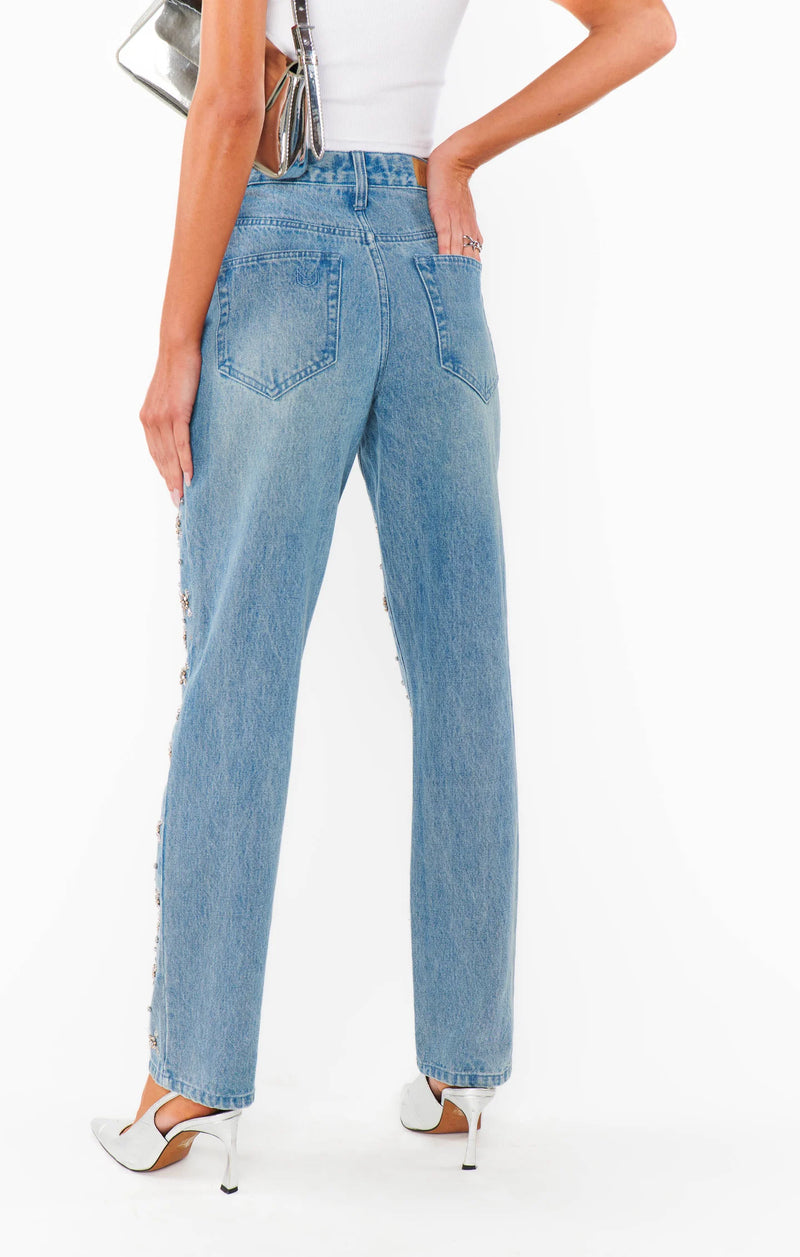 Light blue jeans worn by a person on a white background