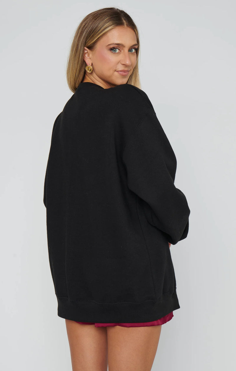 Person wearing a black oversized sweater on a white background