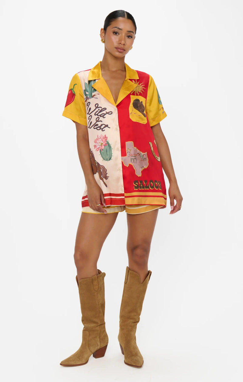 Woman wearing a colorful patterned dress with a white background