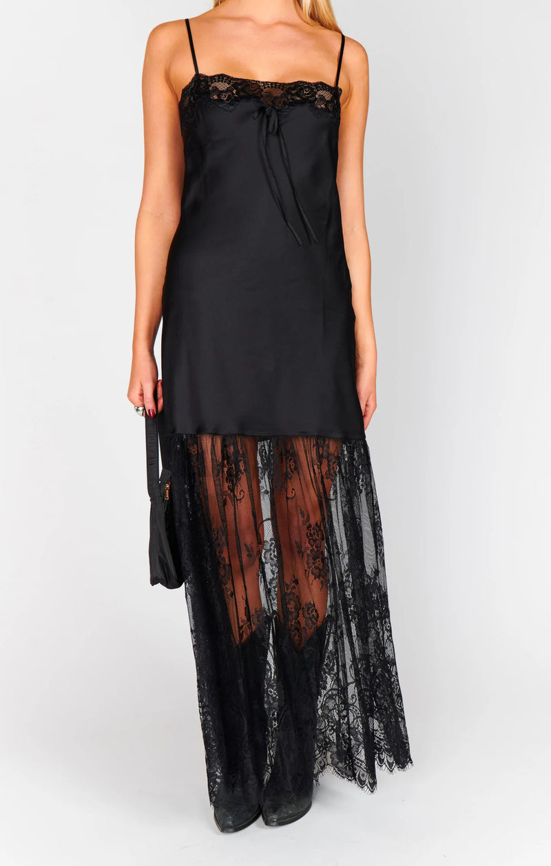 Black lace dress with sheer overlay on a white background