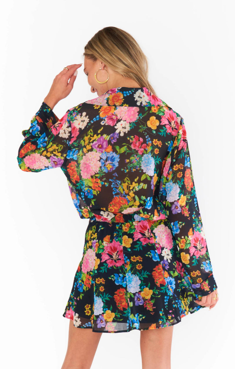 Woman wearing sheer floral shirt with black background