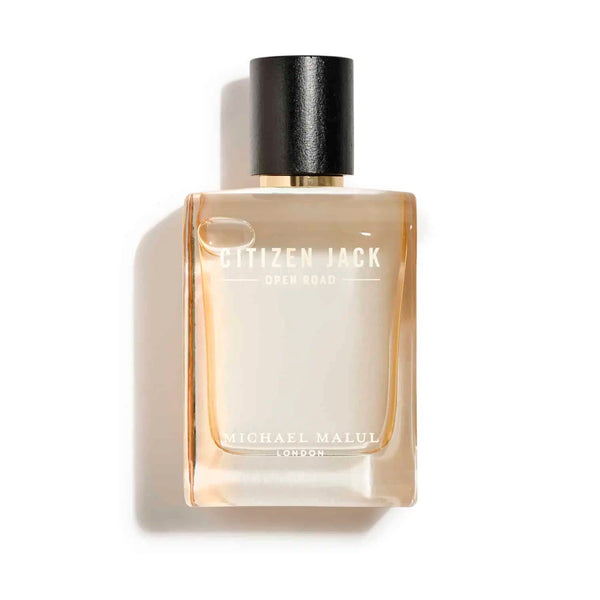 Cologne in yellowish clear bottle with black cap and white writing that says "Citizen Jack Open Road Michael Malul London"