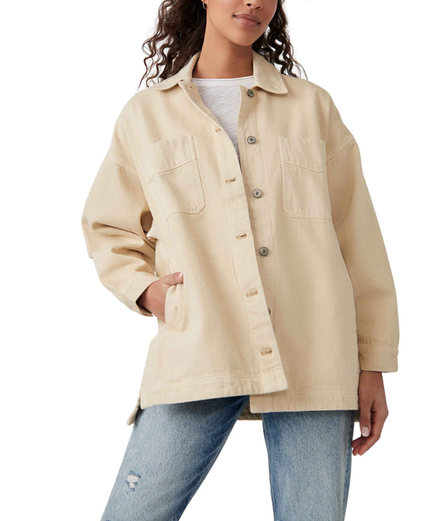 Woman wearing cream color denim jacket
