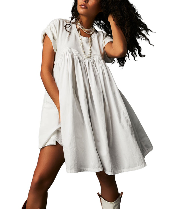 Woman wearing white short sleeve mini dress with sweetheart neckline detail