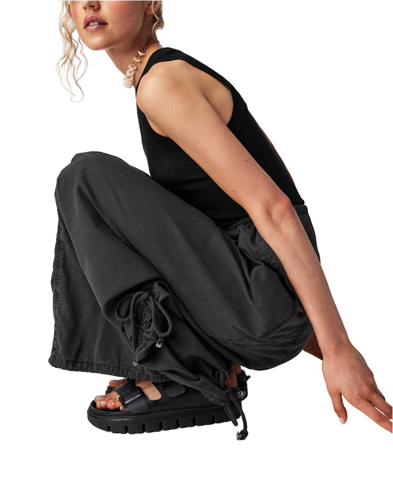 Woman wearing black parachute maxi skirt with cinch feature at the top and the bottom