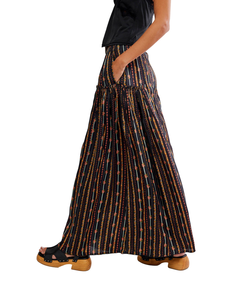 Long patterned skirt worn by a person on a white background