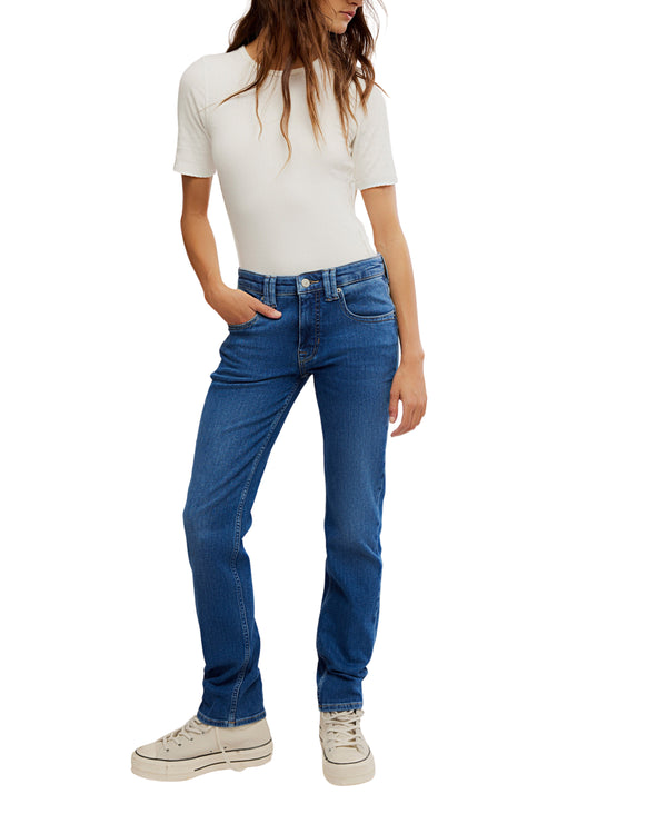 Person wearing blue jeans and a white top on a white background