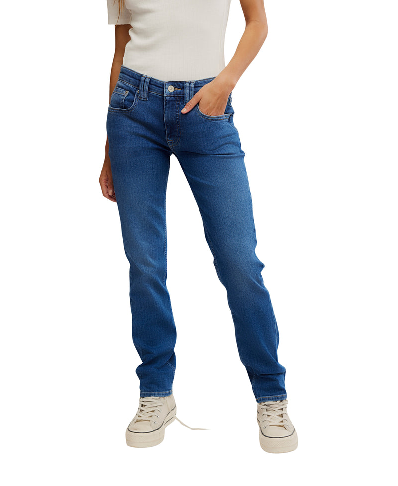 Person wearing blue jeans and white sneakers on a white background