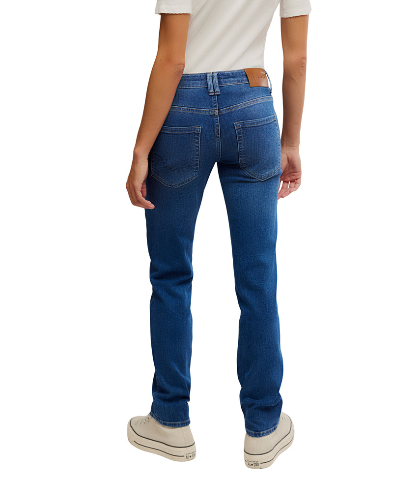 Person wearing blue jeans on a white background