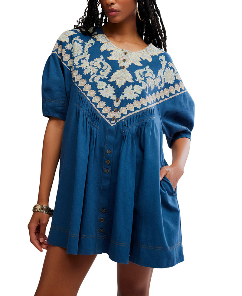 Blue dress with white floral embroidery on a white background