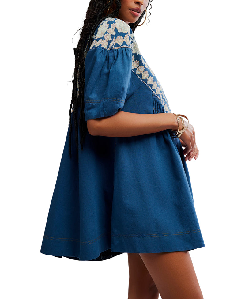 Blue dress with white floral embroidery on a white background