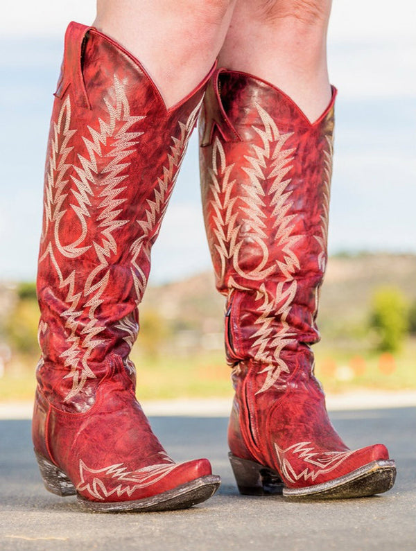 A pair of OLD GRINGO WOMEN'S MAYRA RED RELAXED BOOT worn