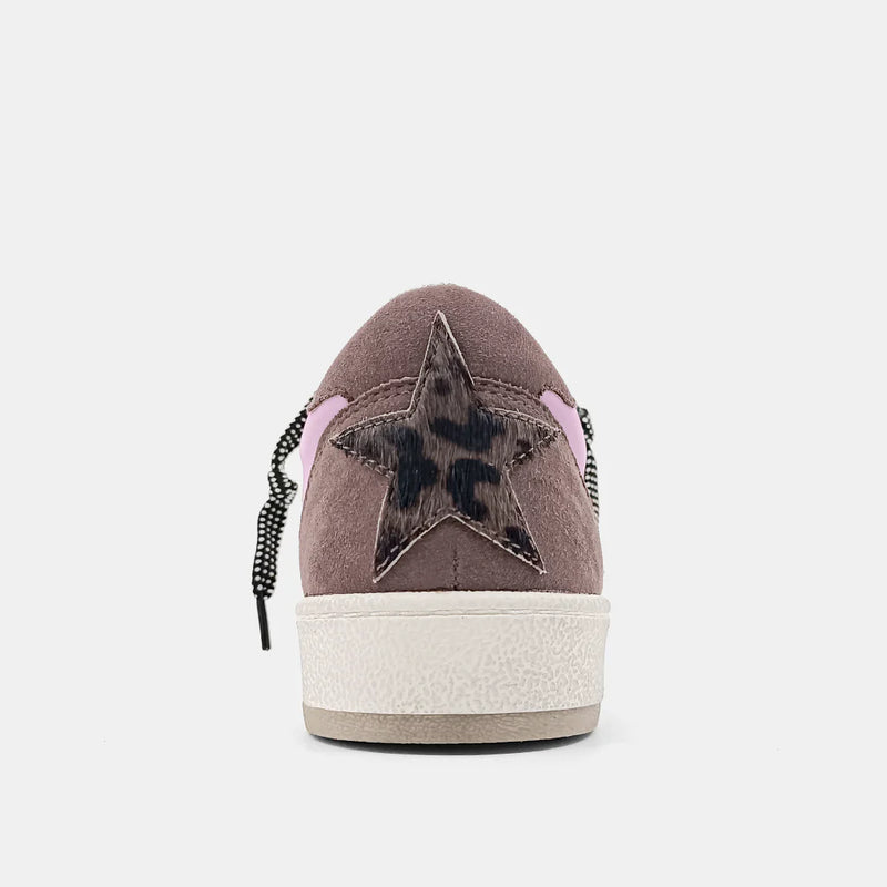 White, purple and brown sneaker with hair on hide star on the back