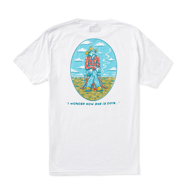 Short sleeve white t-shirt with graphic displaying a cowboy sitting on a stump, cigarette in hand, looking off in the distance with words "I wonder how she is doin..." below. This is an image of the back of the shirt.